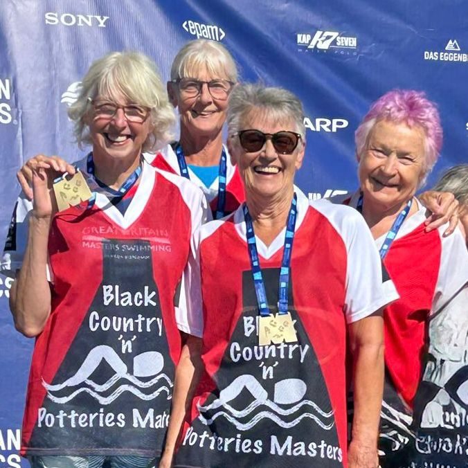 BCPM relay team on podium with gold medals